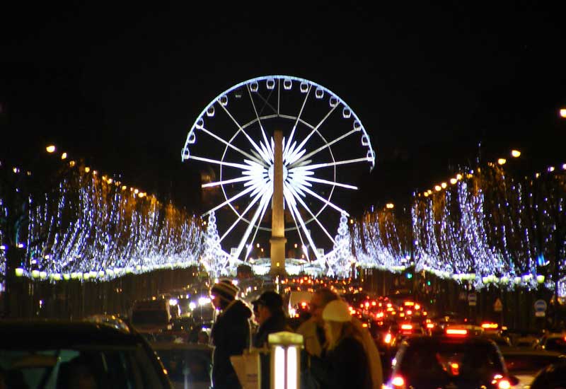 Spectacular view of the Champs Elysées with the Christmas lights and the Ferris wheel in the background on Place de la Concorde.